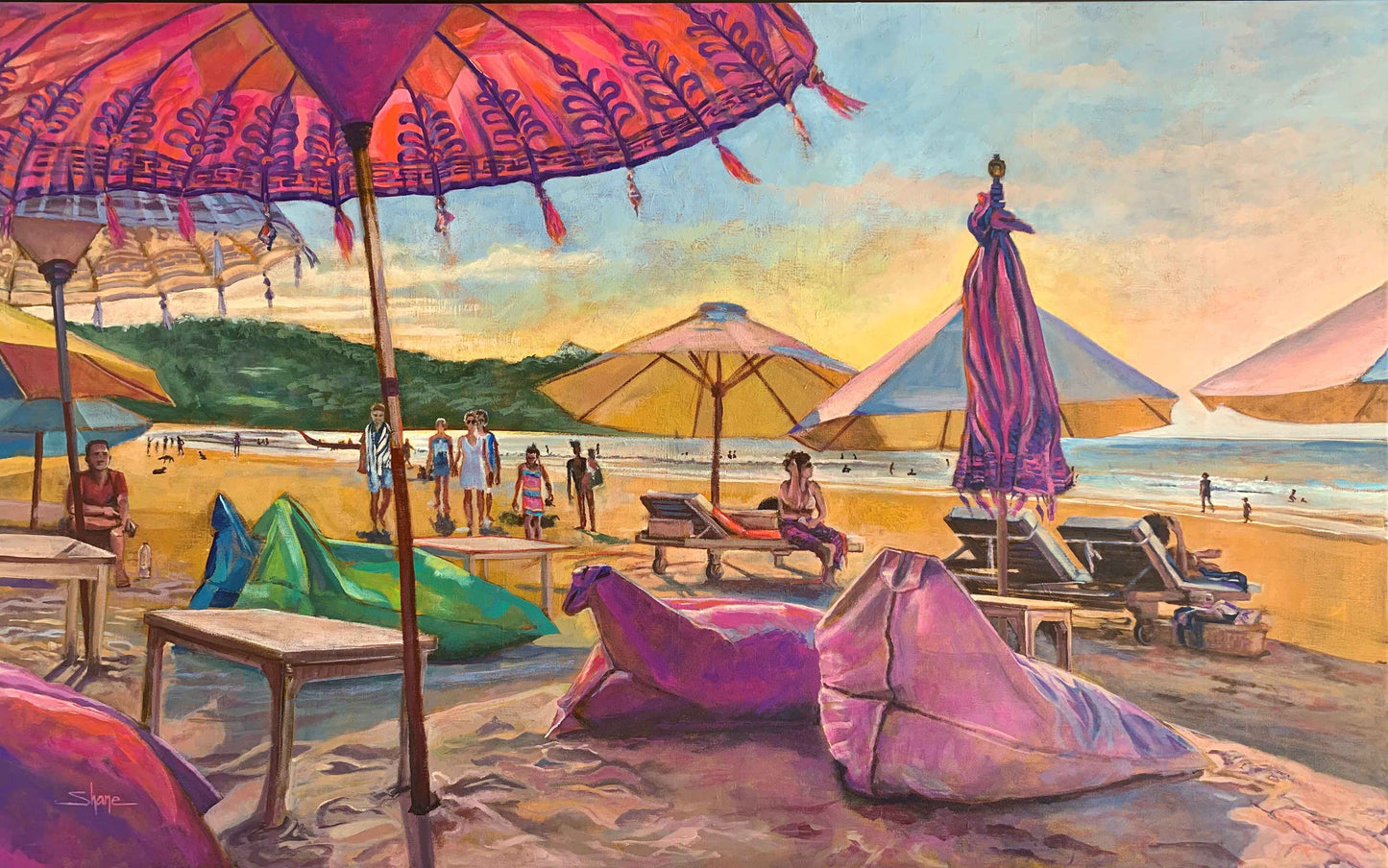 People relaxing on Jimbaran Bay Beach with colourful beanbags and embellished Balinese umbrellas